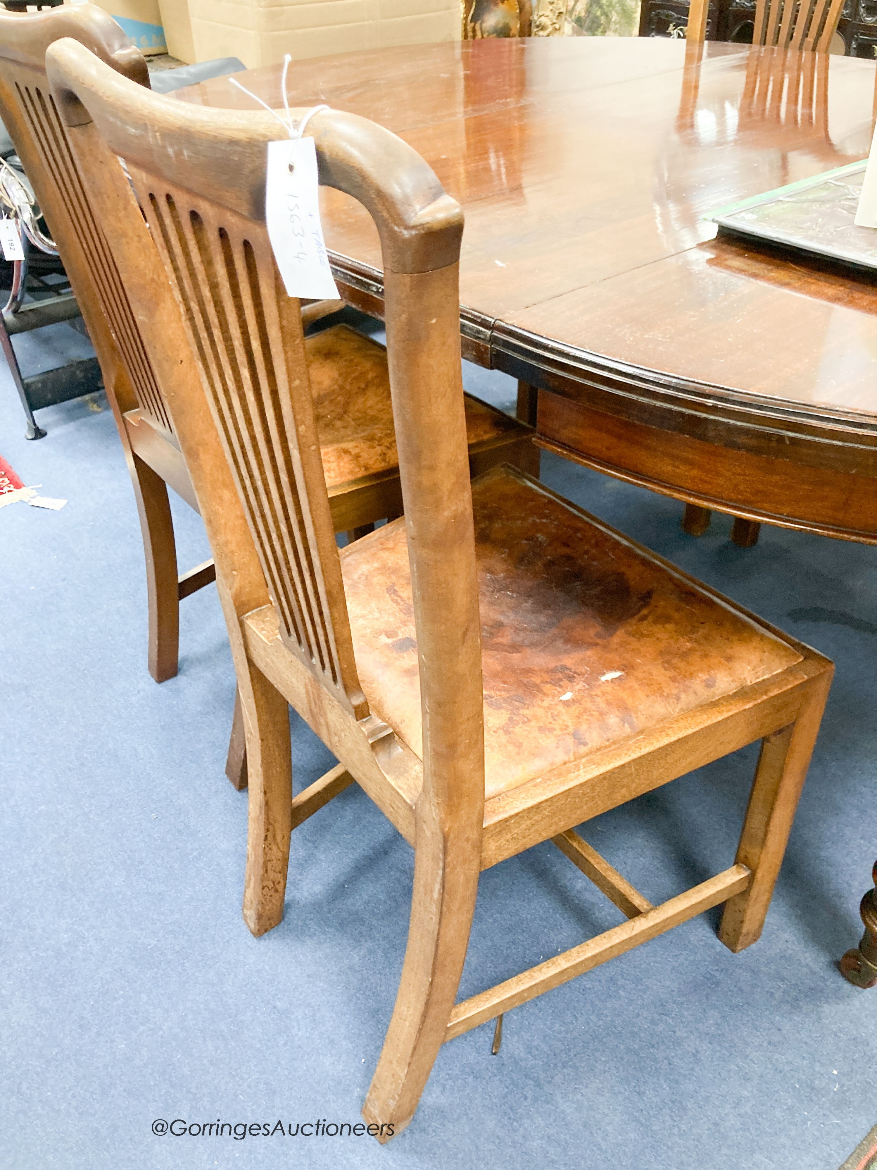 An Edwardian mahogany oval extending dining table, length 180cm extended with one spare leaf, width 120cm, height 74cm together with four George III style mahogany dining chairs